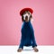 Eyes of Weimaraner wearing stylish costume with red beret over pink studio background. Dog clothes. Pet Supplies