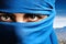 The eyes of a woman in a blue niqab. Ramadan as a time of fasting and prayer for Muslims