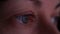 Eyes of a woman close-up in front of a monitor.