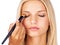 Eyeshadow, makeup brush and woman in studio with hands for beauty, wellness or glamour makeover on white background