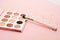 Eyeshadow makeup brushes collection professional cosmetics accessories on pink background