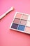 Eyeshadow palette and make-up brush on coral background, eye shadows cosmetics product for luxury beauty brand promotion and