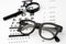 Eyesight test with black small magnifier, glasses and snellen chart