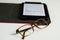 Eyestrain glasses and ebook reader isolated