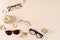 Eyewear fashion autumn collection. Trendy glasses and sunglasses in plastic and matallic frame on a beige background with golden