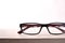 Eyewear on wood table and white background front view detail