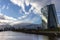 EZB Frankfurt EuropÃ¤ische Zentralbank European Central Bank cloudy blue sky with Skyline in background