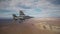 F-16 Falcon fighter jet flying over a desert landscape armed with bombs
