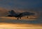 F/A-18 Hornet flying into the warm golden sunset sun