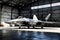 F-22 Raptor Stationed within the Shadowy Confines of a Vast Military Hangar: Spotlights Cascading Dramatic Illumination