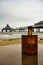 F, Germany - November 2018: A Rusty Barrel in The Foreground, the Pier in The Background