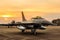 F16 falcon fighter jet on sunset background