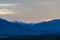 Faakersee - Panoramic sunset view on snow capped mountain peak Mangart seen from lake Faak in Carinthia