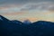 Faakersee - Panoramic sunset view on snow capped mountain peak Mangart seen from lake Faak in Carinthia