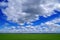 Faboulos natural cloudly blue sky and green field