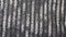 Fabric background with metallic weave.  Coarse woven gray material with shiny inserts.  Texture of rough curtain fabric with inter