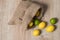 Fabric bag with lemons. Full sack of lemons on a wooden background