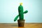 Fabric cactus on wooden table and white background