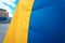 Fabric curved flag of Ukraine. Close up shot, background