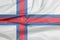 Fabric flag of Faroe Islands. Crease of Faroe Islands flag background.