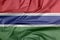 Fabric flag of Gambia. Crease of Gambian flag background.