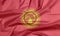 Fabric flag of Kyrgyzstan. Crease of Kyrgyz flag background.