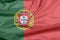 Fabric flag of Portugal. Crease of Portuguese flag background.