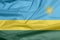 Fabric flag of Rwanda. Crease of Rwandan flag background.