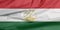 Fabric flag of Tajikistan. Crease of Tajik flag background.