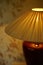 Fabric lampshade with golden warm light. Close-up, selective focus