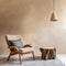 Fabric lounge chair and wood stump side table against beige stucco wall with copy space. Rustic minimalist home interior design of