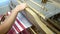 fabric making loom close-up. a man makes fabric on a satre wooden loom slow mo