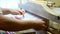 fabric making loom close-up. a man makes fabric on a satre wooden loom slow mo