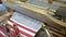 fabric making loom close-up. a man makes fabric on a satre wooden loom slow mo