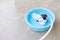 Fabric mask is soak in basin on cement floor that the water is overflowing for washing, clean and reuse to prevent the infection