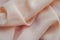 Fabric with wavy holds in peachy pink color