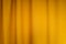 Fabric yellow curtains with folds . Abstract background, curtain, drapes gold fabric.