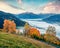 Fabulous view of Zell lake. Foggy autumn sunrise of Austrian town - Zell am See, south of the city of Salzburg. Beauty of nature