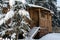 Fabulous wooden hut covered with snow in the forest