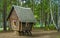 Fabulous wooden hut stands on stumps in the forest