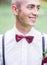 Fabulous young groom with silk wine bow tie