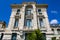 Facade of ancient baroque building with balconies and stucco molding