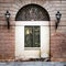 Facade of an ancient Italian villa with artistic iron grill.