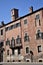 Facade of an ancient medieval palace illuminated by the sun in Verona.