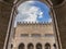 The facade of the ancient Palazzo dell`Arengo framed in an arch of the ancient fish market, historic center of Rimini, Italy