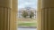 Facade of architectural building through columns. Historic house in downtown.