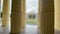 Facade of architectural building through columns. Historic house in downtown.