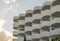 Facade with balconies of a white tourist hotel