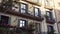 Facade of Barcelona old house with balconies with plants. Urban jungles. Ecological living