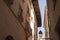 Facade of beige Mediterranean Spanish houses against a clear blue sky